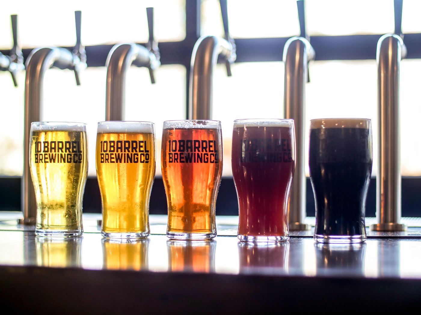 Five beers in a row from pale gold to black